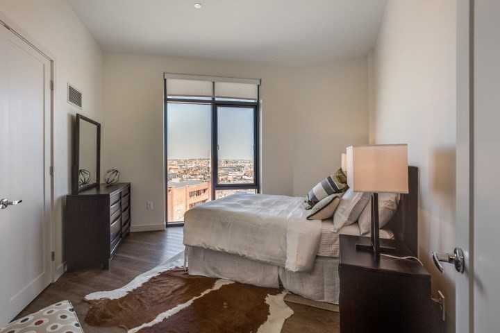 1 Canal Street, Unit 1202 Boston, MA 02114 - Photo 6 of 12 a bedroom with a bed and wooden floor