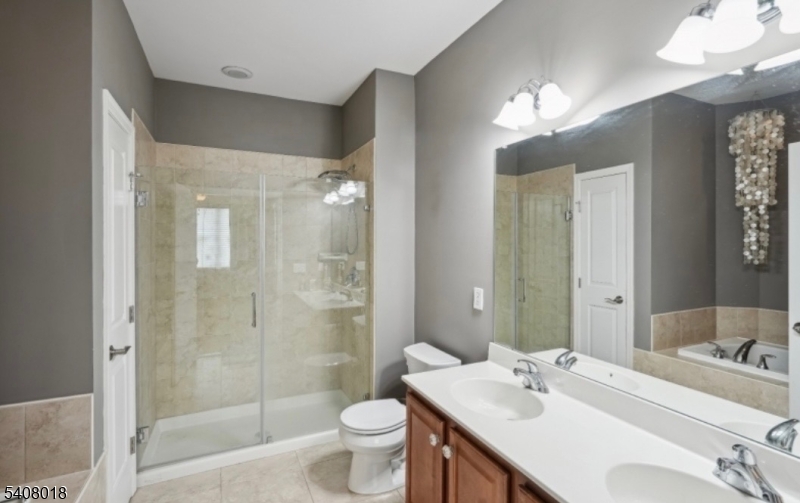 169 Tarrington Road, Unit 203 Hamburg, NJ 07419 - Photo 14 of 15 a bathroom with a double vanity sink toilet and shower