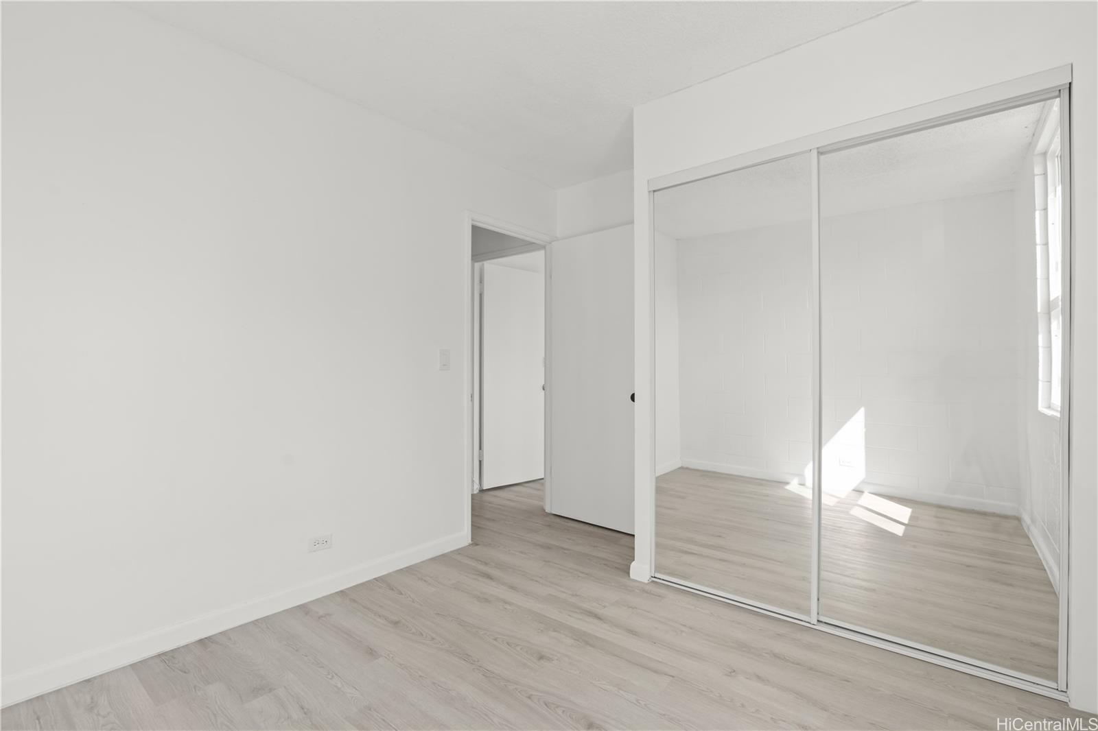 98-1042 Moanalua Road, Unit 2201 Aiea, HI 96701 - Photo 13 of 19 a view of empty room with wooden floor