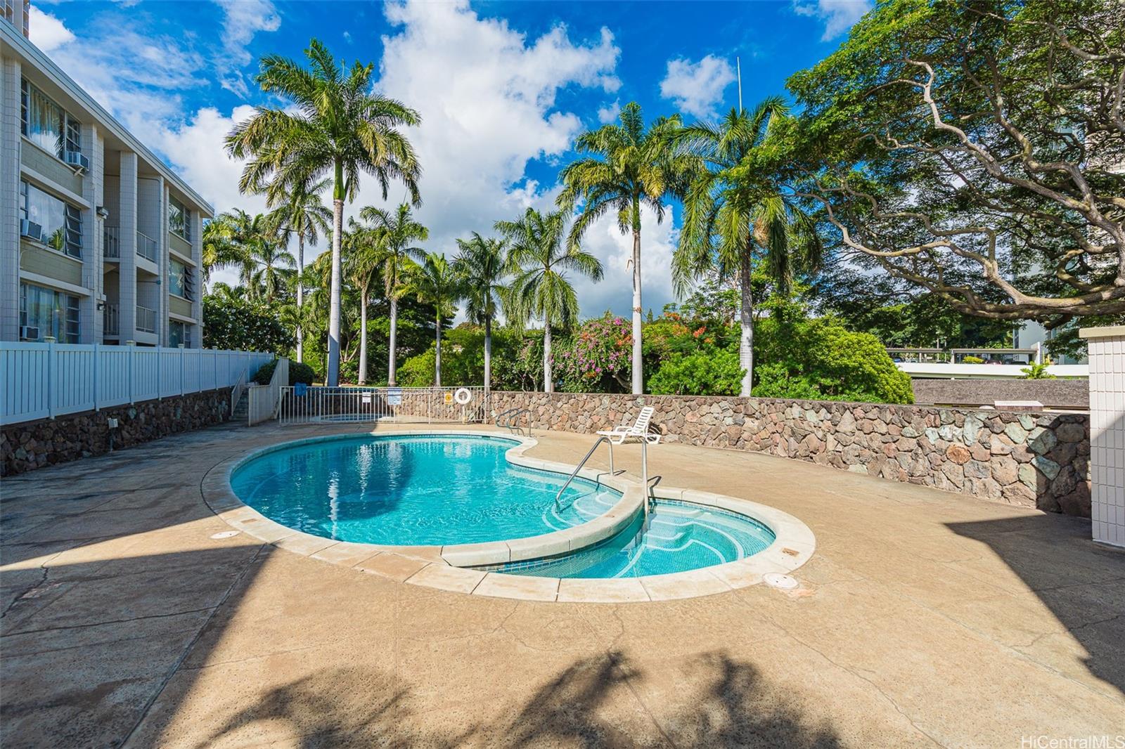 98-1042 Moanalua Road, Unit 2201 Aiea, HI 96701 - Photo 14 of 19 a swimming pool with outdoor seating and yard