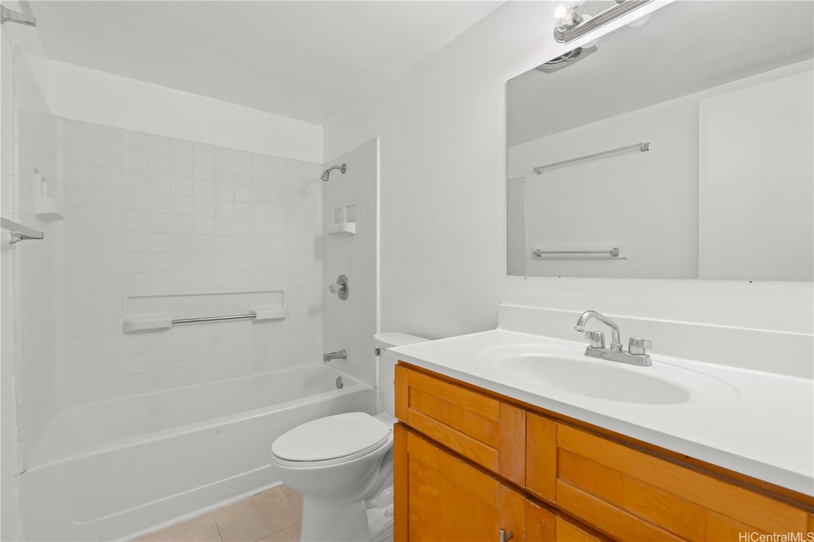 98-1042 Moanalua Road, Unit 2201 Aiea, HI 96701 - Photo 9 of 19 a bathroom with a sink a toilet and shower