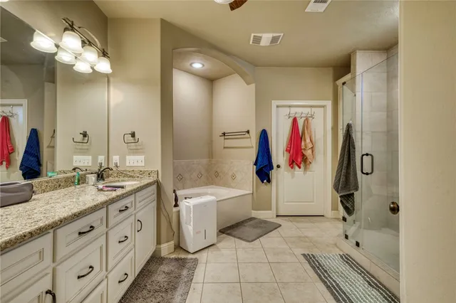a bathroom with a tub sink and mirror