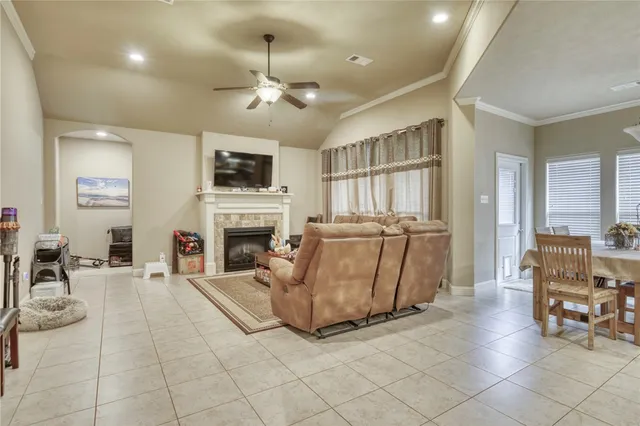 a living room with furniture a flat screen tv and a fireplace