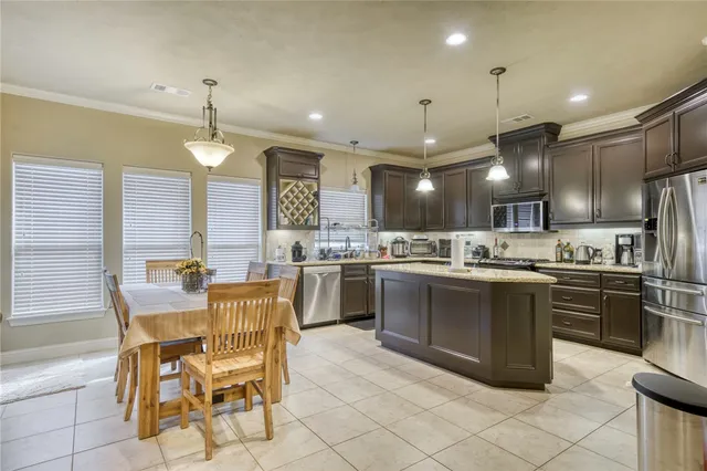 a kitchen with a sink cabinets and stainless steel appliances
