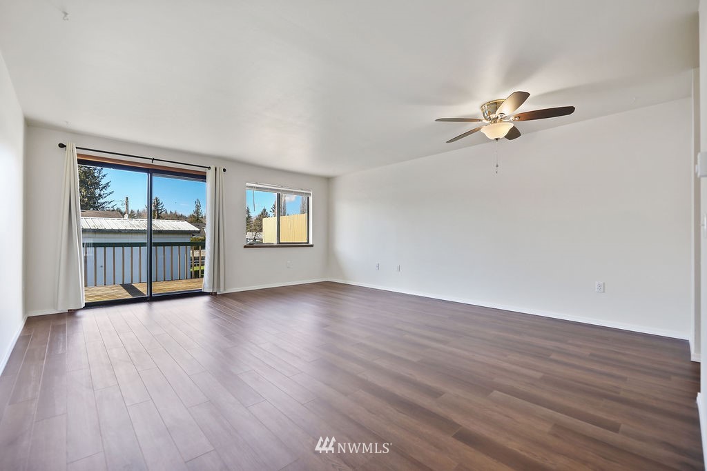 311 Date Street Sultan, WA 98294 - Photo 23 of 29 an empty room with wooden floor and windows