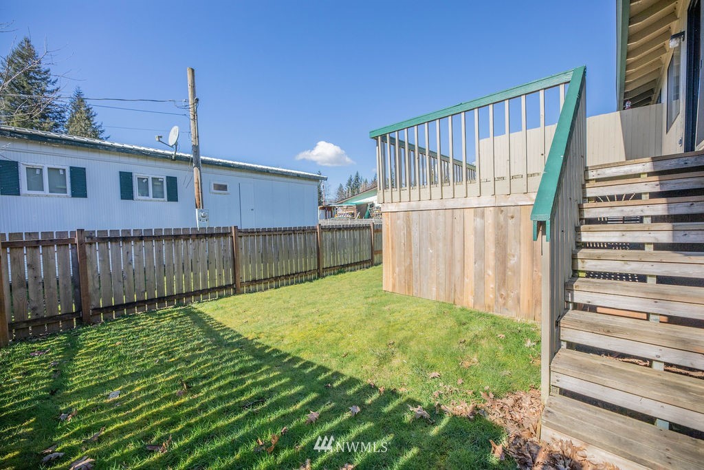 311 Date Street Sultan, WA 98294 - Photo 26 of 29 a view of a backyard with wooden fence