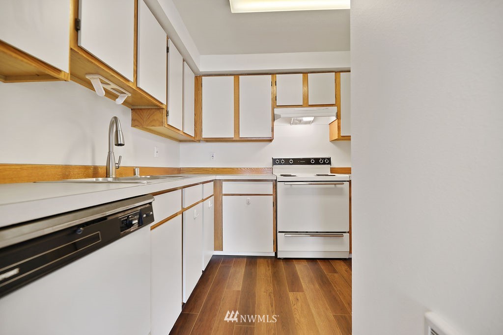 311 Date Street Sultan, WA 98294 - Photo 9 of 29 a view of a kitchen with wooden floor and electronic appliances