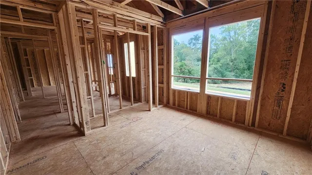 a view of a room with wooden walls and windows