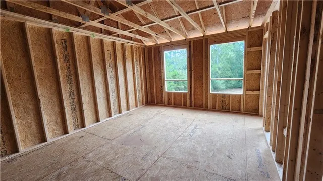 a view of a room with a wooden floor and a window
