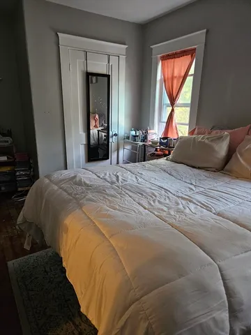 a bedroom with a bed and a window