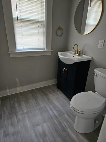 a bathroom with a sink toilet and mirror