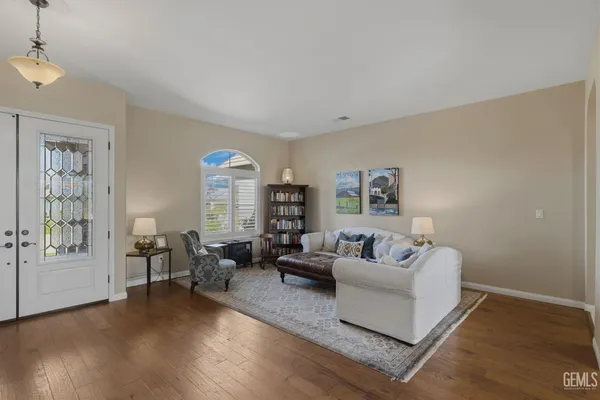 a living room with furniture and a chandelier