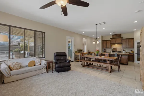 a living room with furniture a flat screen tv and a window