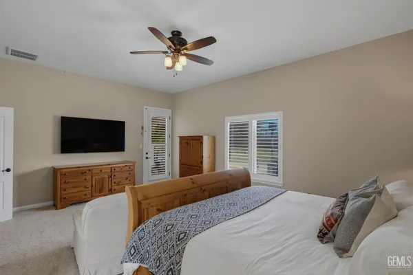 a bedroom that has a bed and a chandelier