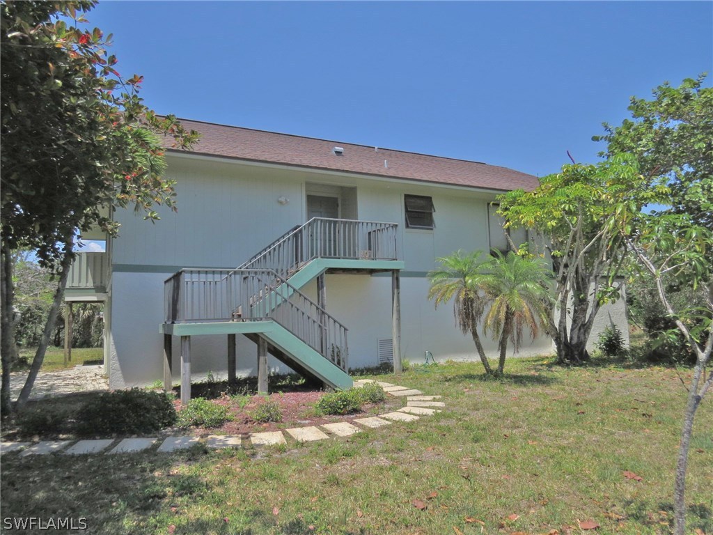 1439 Albatross Road Sanibel, FL 33957 - Photo 21 of 21 a view of a house with a yard