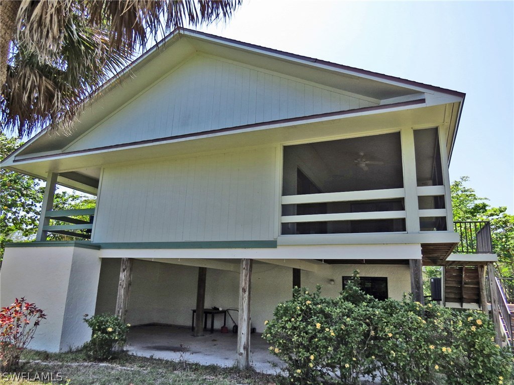1439 Albatross Road Sanibel, FL 33957 - Photo 3 of 21 a front view of a house with a yard