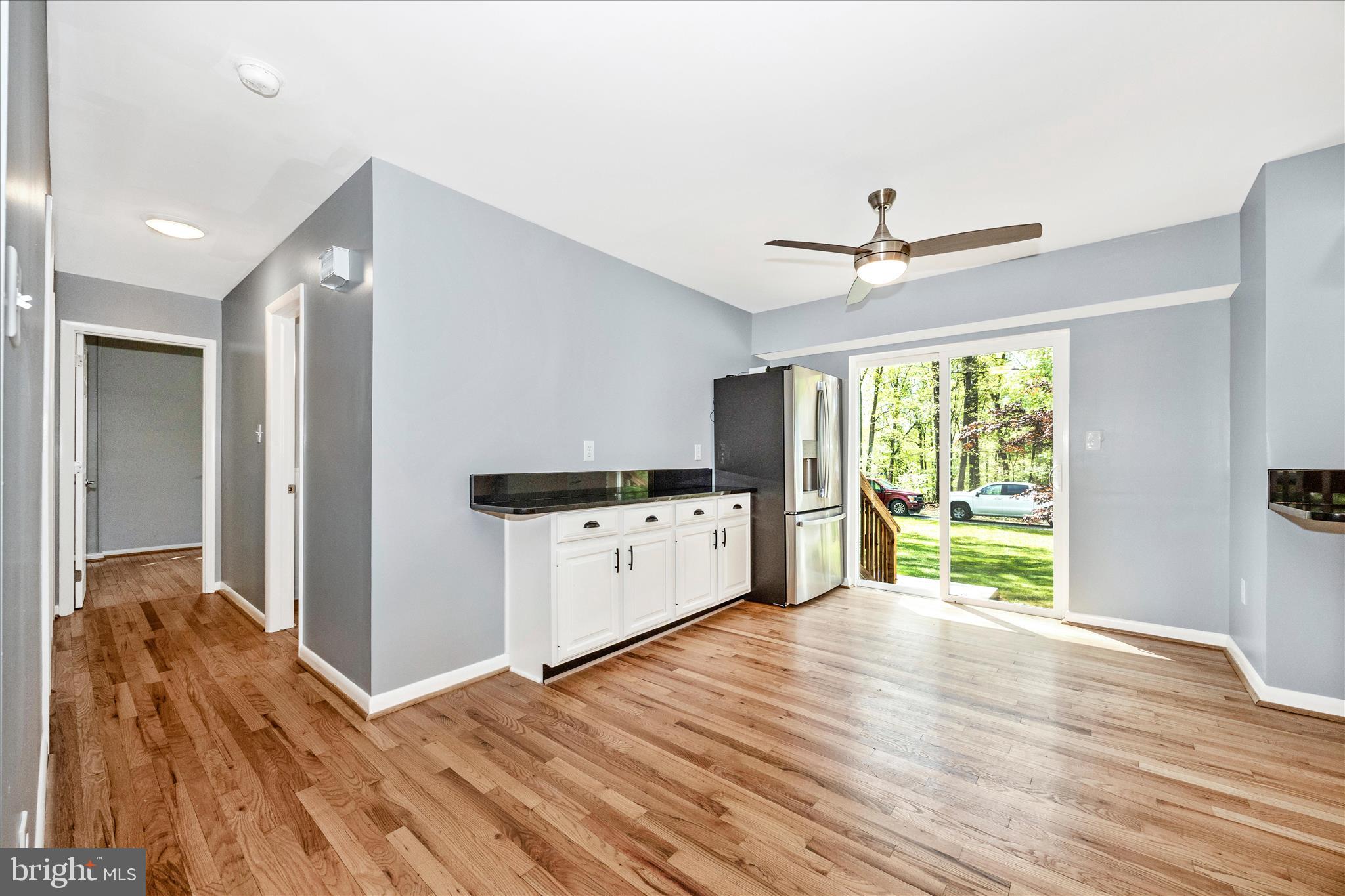 6518 Woodville Road Mount Airy, MD 21771 - Photo 16 of 53 a kitchen with stainless steel appliances kitchen island hardwood floor and a window