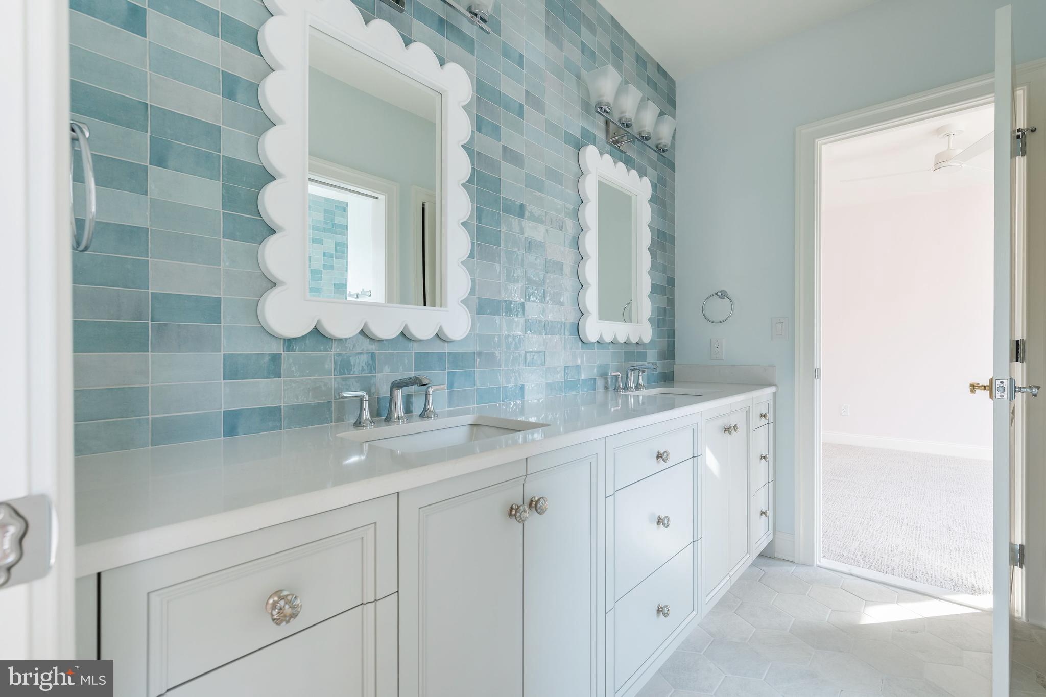 427 Radnor Street Road Wayne, PA 19087 - Photo 21 of 36 a bathroom with a double vanity sink and mirror