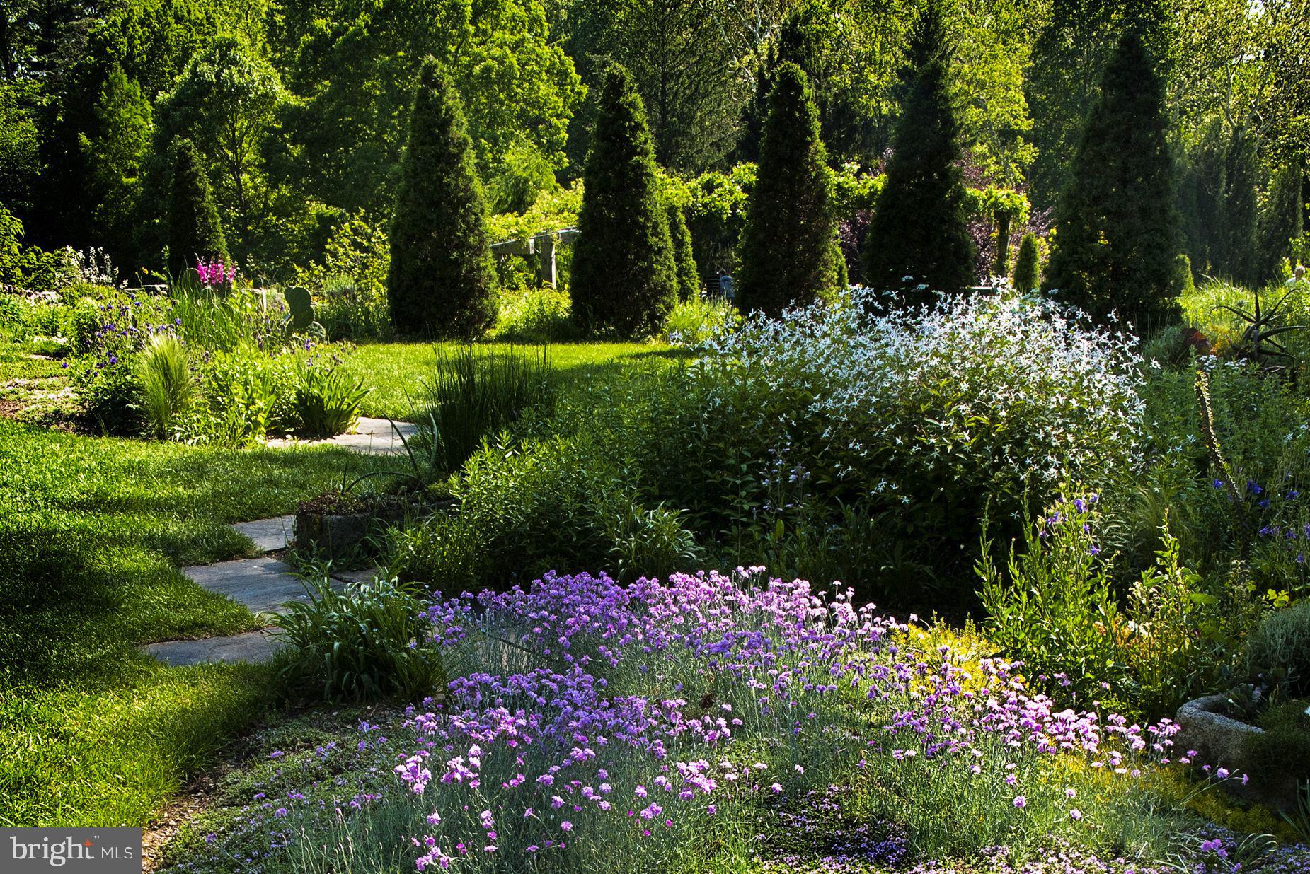 427 Radnor Street Road Wayne, PA 19087 - Photo 33 of 36 a view of a garden with flowers and trees
