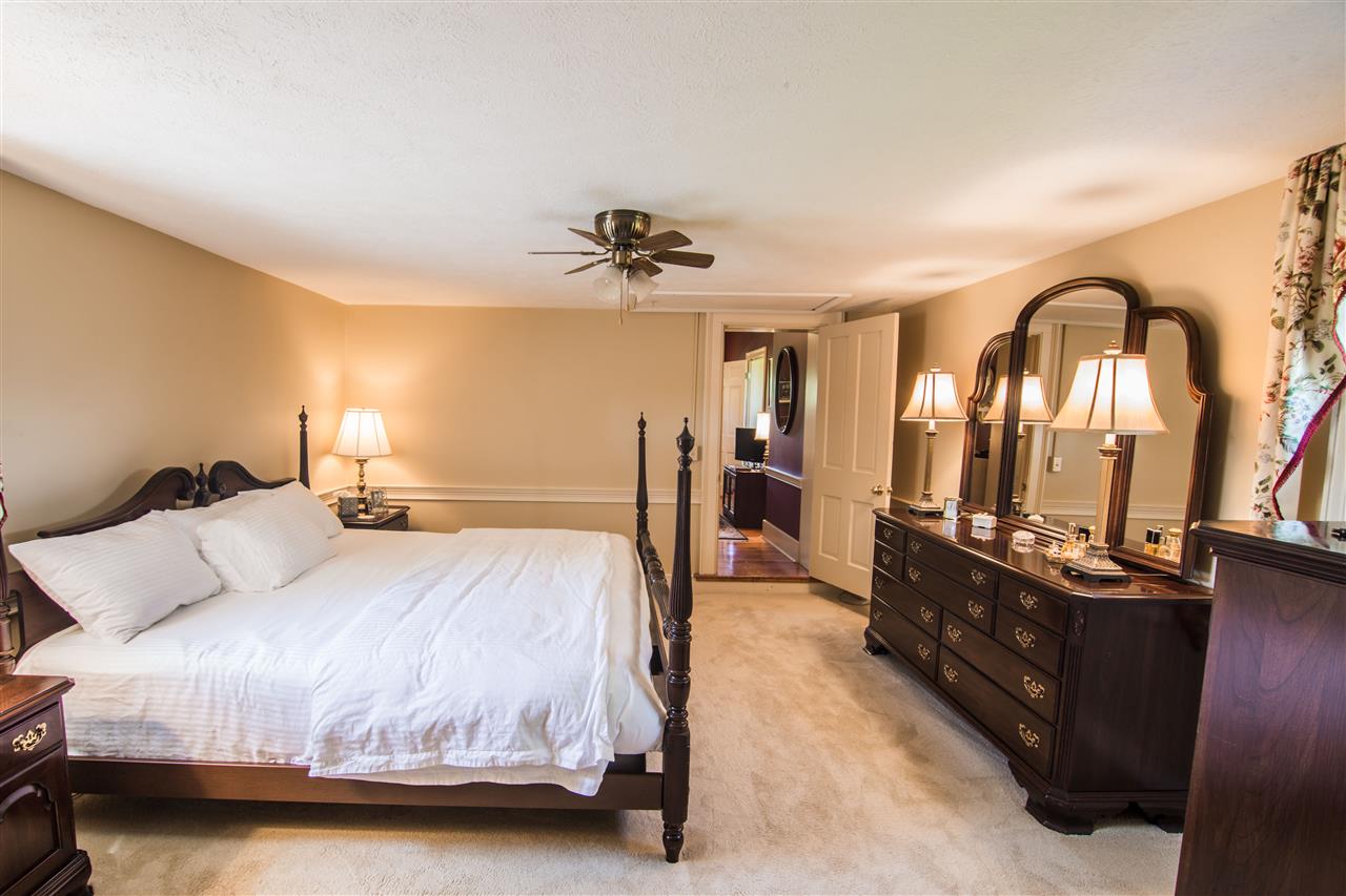 6389 Spring Creek Road Bridgewater, VA 22812 - Photo 34 of 41 a bedroom with a bed and a chandelier