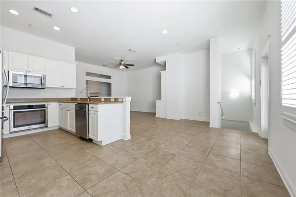 a view of a kitchen with a sink stove and cabinets