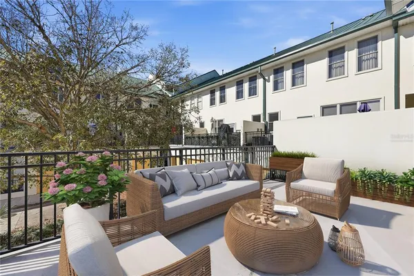a balcony with furniture and a potted plant
