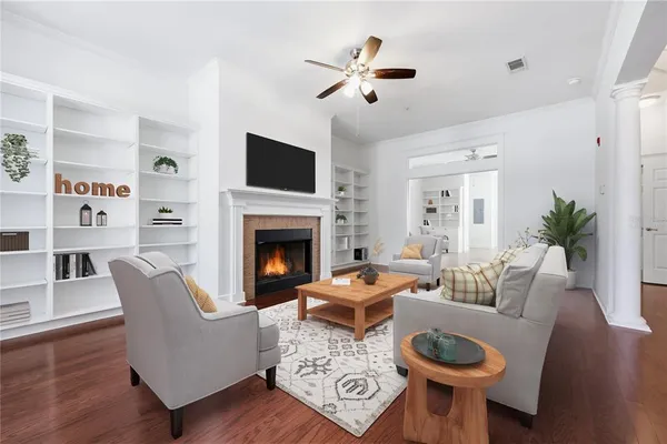 a living room with furniture a flat screen tv and a fireplace
