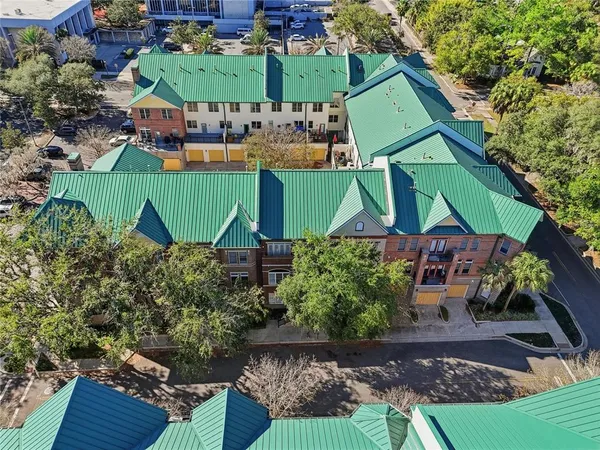 an aerial view of multiple houses with yard
