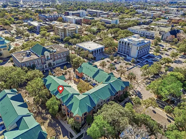 an aerial view of multiple houses with yard