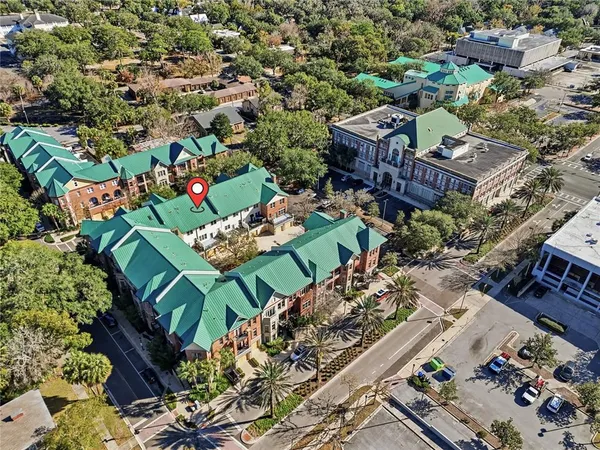 an aerial view of a house with a yard