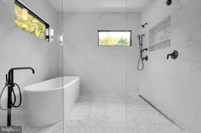 a bathroom with a sink a bathtub and shower