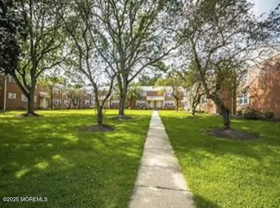 a front view of a building with a yard