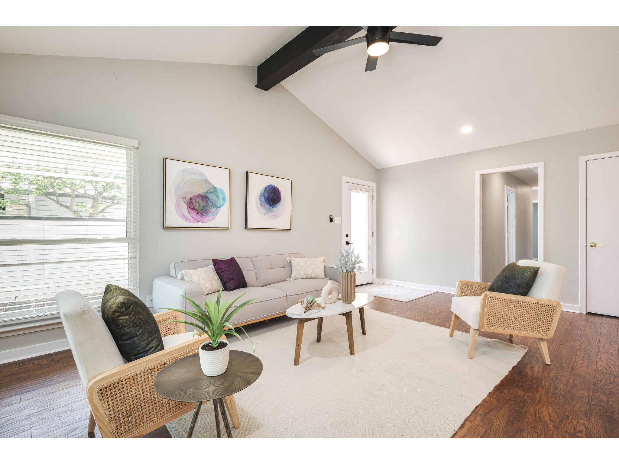 a living room with furniture and wooden floor