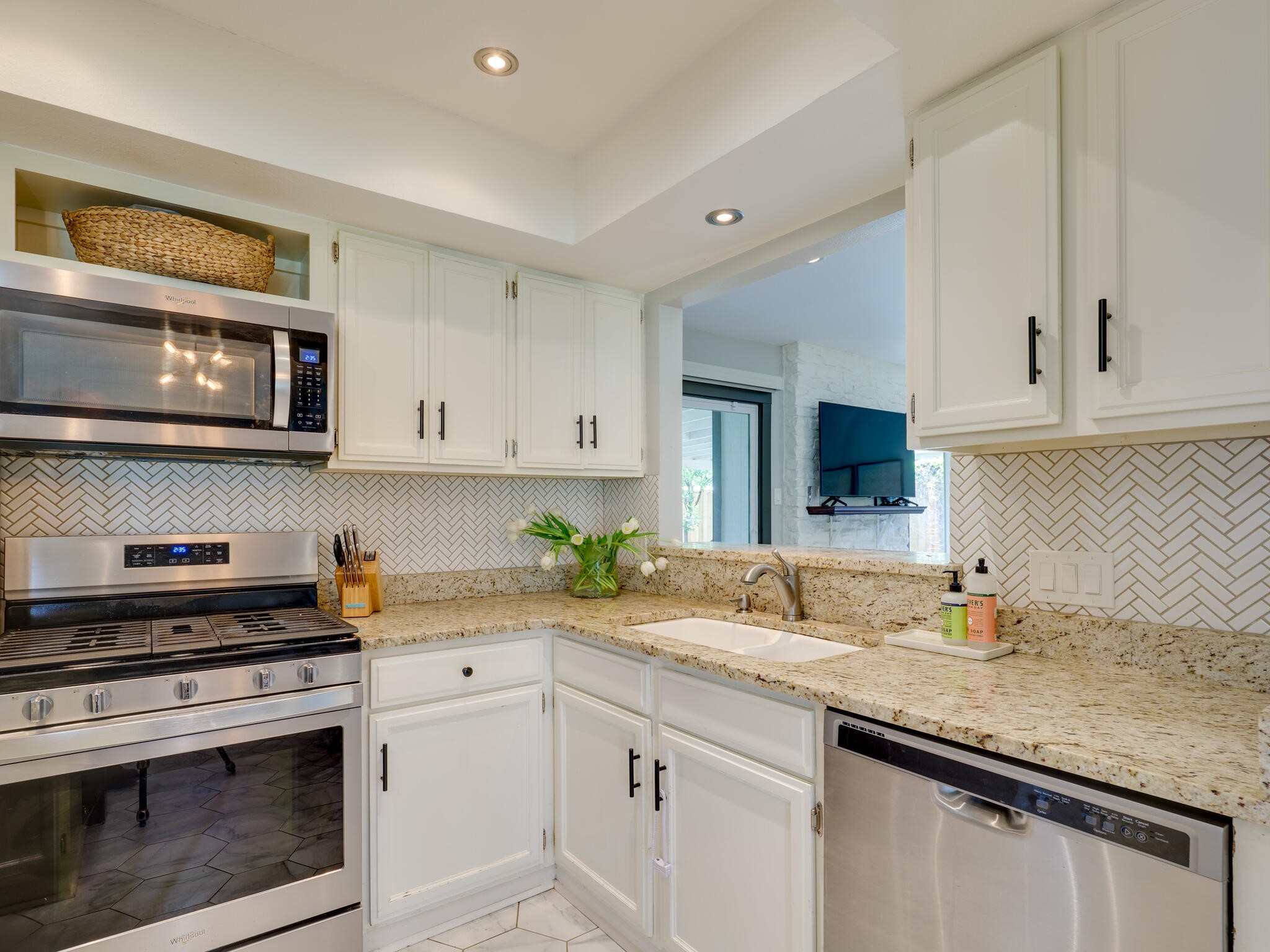 3203 Foster Lane Austin, TX 78757 - Photo 12 of 37 a kitchen with stainless steel appliances granite countertop a sink and a stove