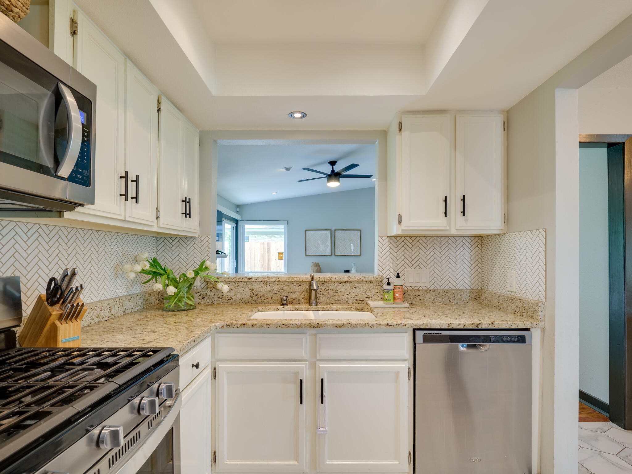 3203 Foster Lane Austin, TX 78757 - Photo 13 of 37 a kitchen with stainless steel appliances granite countertop a sink stove and cabinets