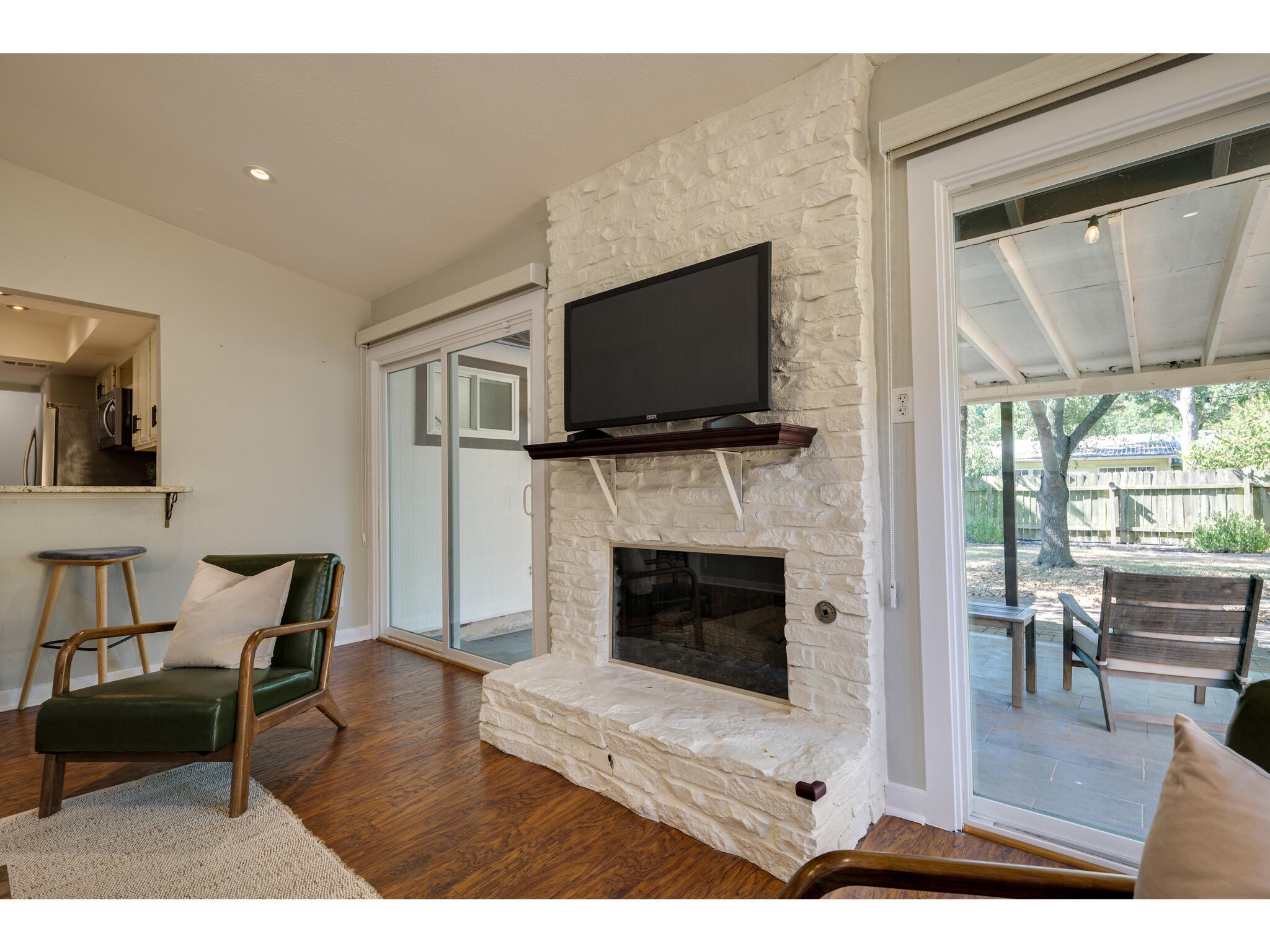 3203 Foster Lane Austin, TX 78757 - Photo 16 of 37 a living room with furniture a flat screen tv and a fireplace