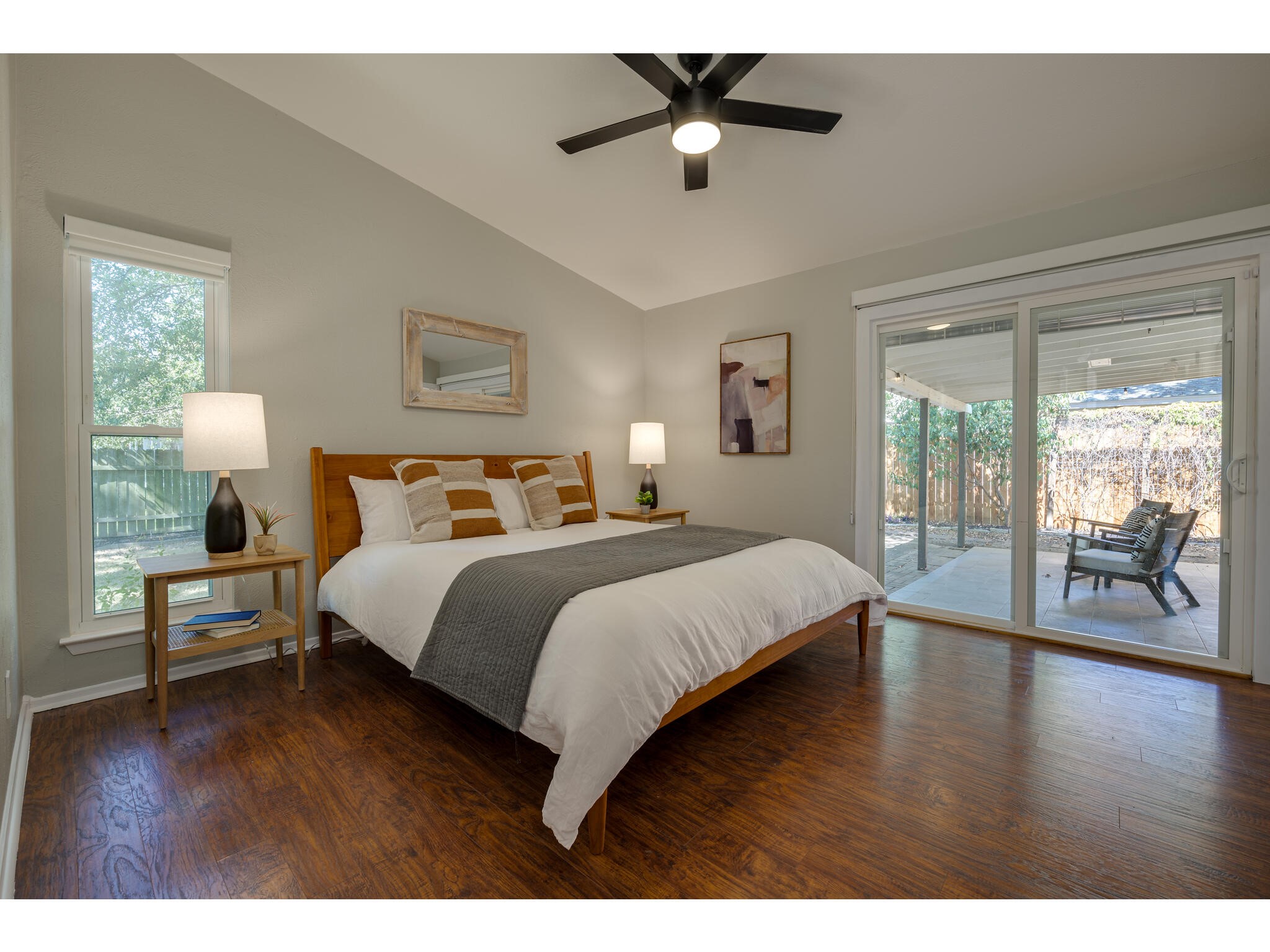 3203 Foster Lane Austin, TX 78757 - Photo 17 of 37 a bedroom with a large bed and a wooden floor