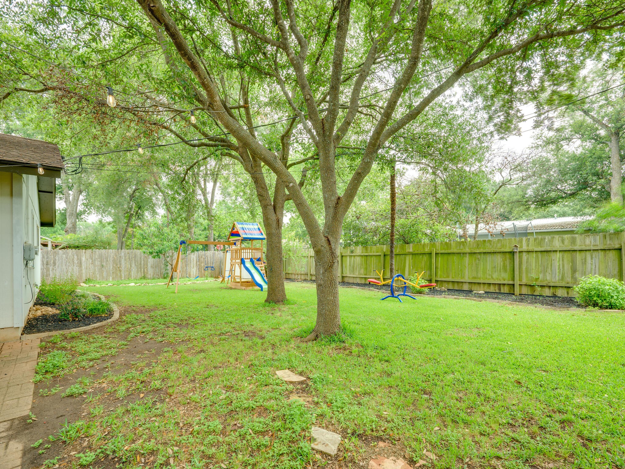 3203 Foster Lane Austin, TX 78757 - Photo 33 of 37 a view of a backyard with large trees and plants