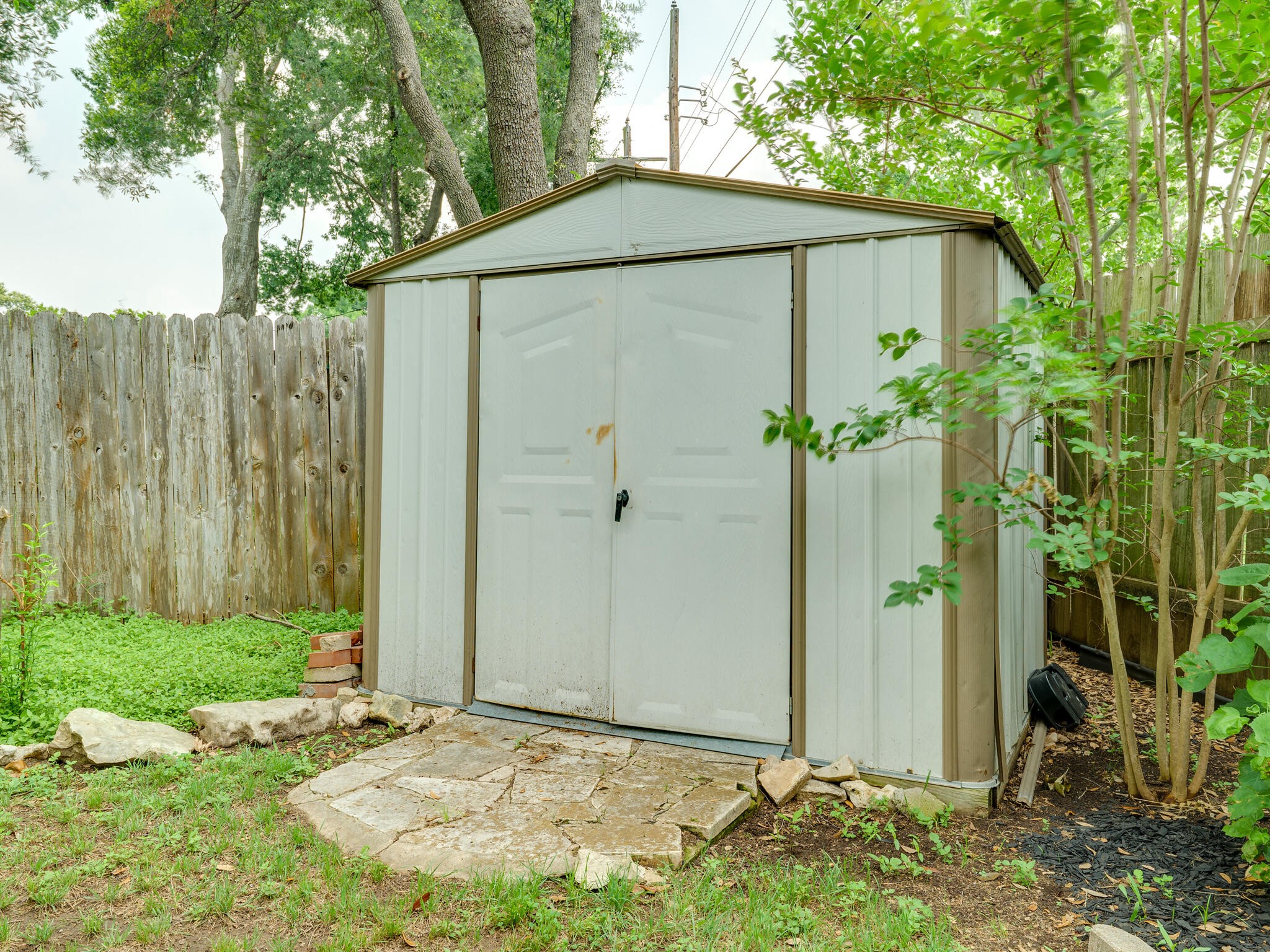 3203 Foster Lane Austin, TX 78757 - Photo 36 of 37 a backyard of a house with potted plants and a tree