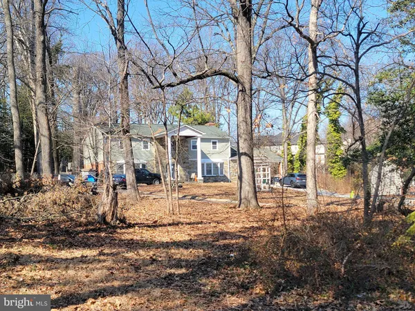 a view of a house with a yard covered with snow