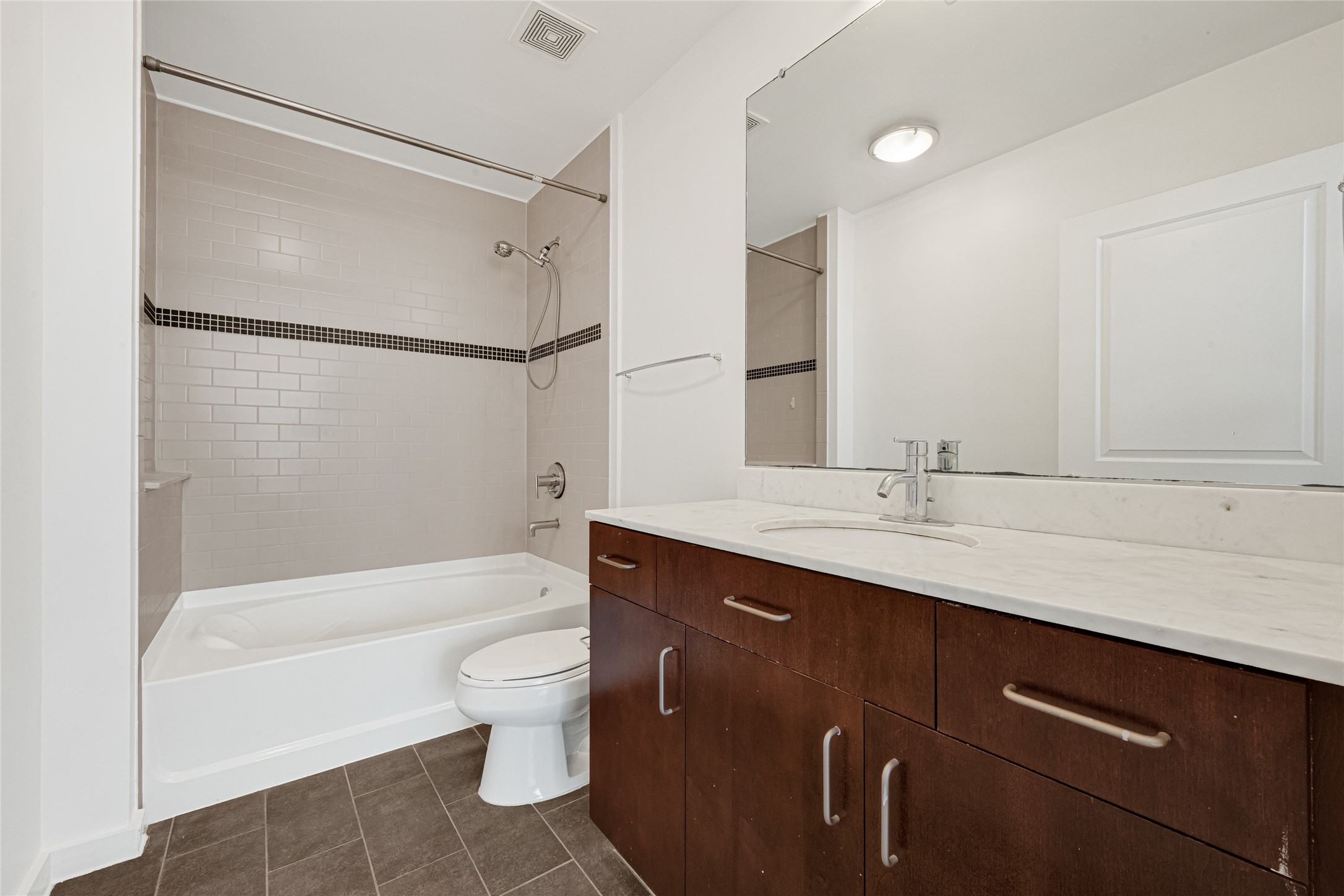 5925 Almeda Road, Unit 12308 Houston, TX 77004 - Photo 13 of 48 a bathroom with a double vanity sink toilet mirror and shower