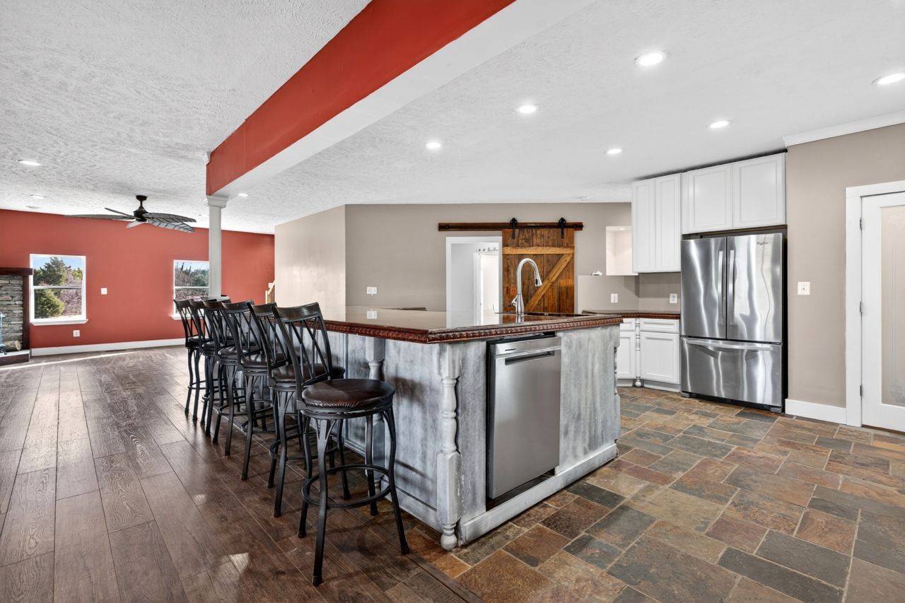 1463 B Vesta Road Lebanon, TN 37090 - Photo 24 of 86 a kitchen with stainless steel appliances granite countertop a refrigerator a stove a sink a dining table and chairs with wooden floor