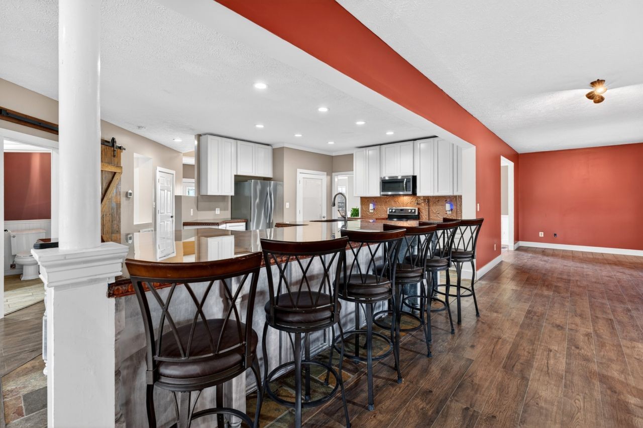 1463 B Vesta Road Lebanon, TN 37090 - Photo 25 of 86 a kitchen with stainless steel appliances kitchen island granite countertop a dining table chairs and granite counter tops