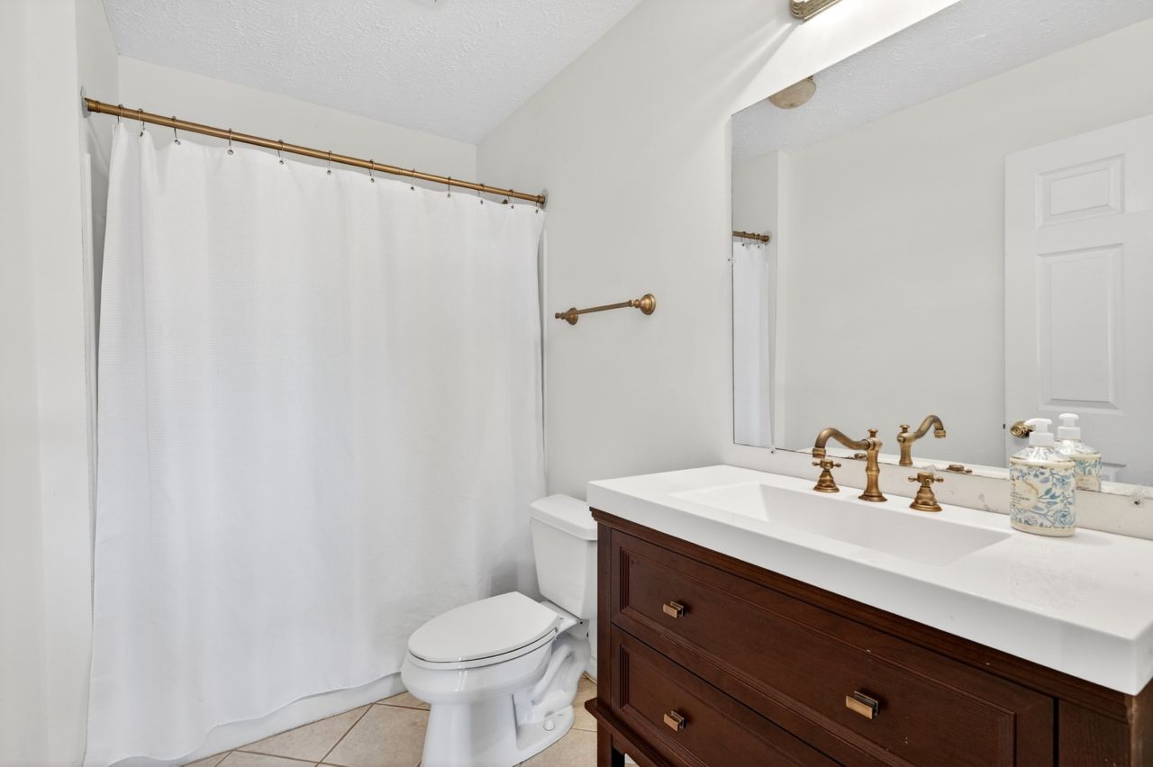 1463 B Vesta Road Lebanon, TN 37090 - Photo 50 of 86 a bathroom with a sink a toilet a mirror and shower curtain
