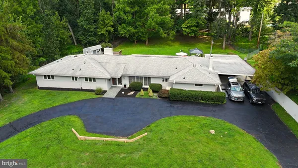 an aerial view of a house with swimming pool and big yard