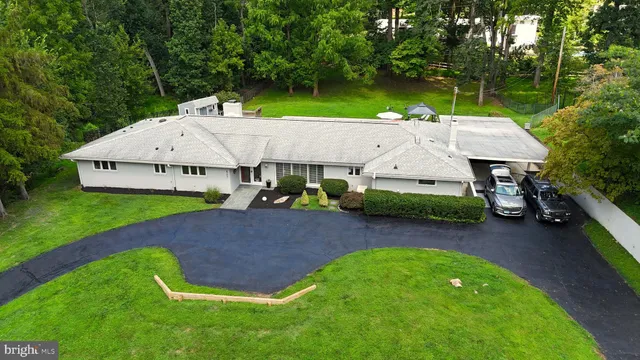 an aerial view of a house with swimming pool and big yard