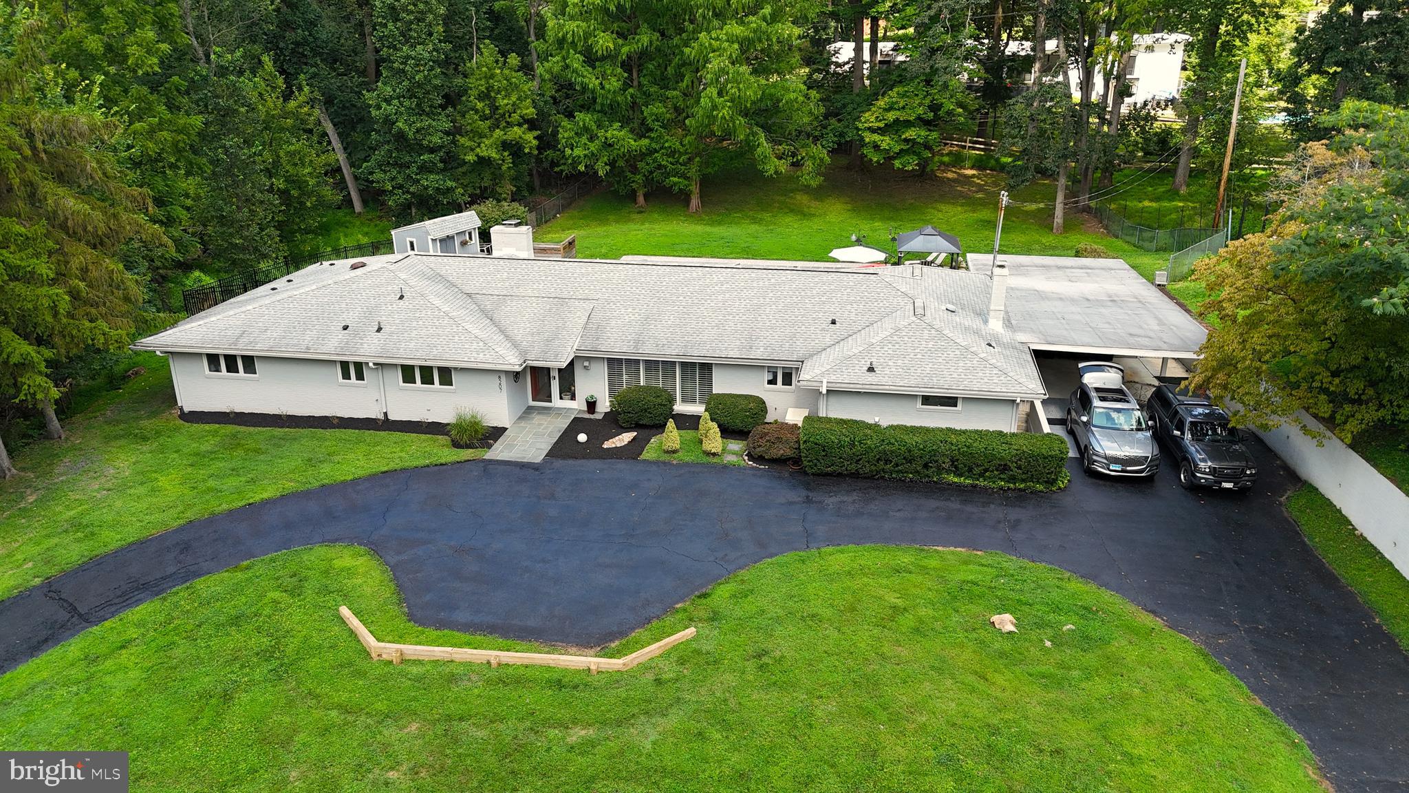 an aerial view of a house with swimming pool and big yard