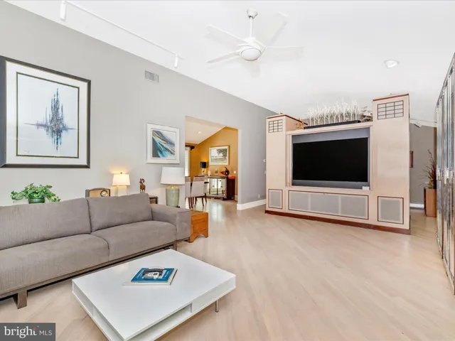 a living room with patio furniture and a floor to ceiling window