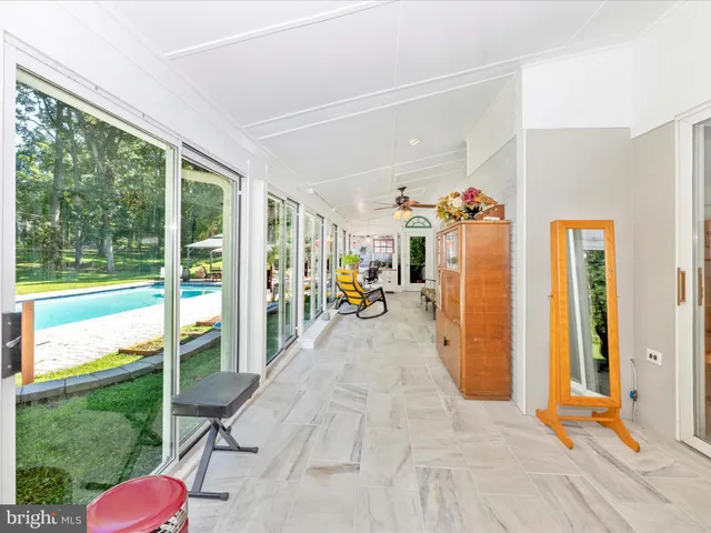 a kitchen with stainless steel appliances a white table chairs and a refrigerator