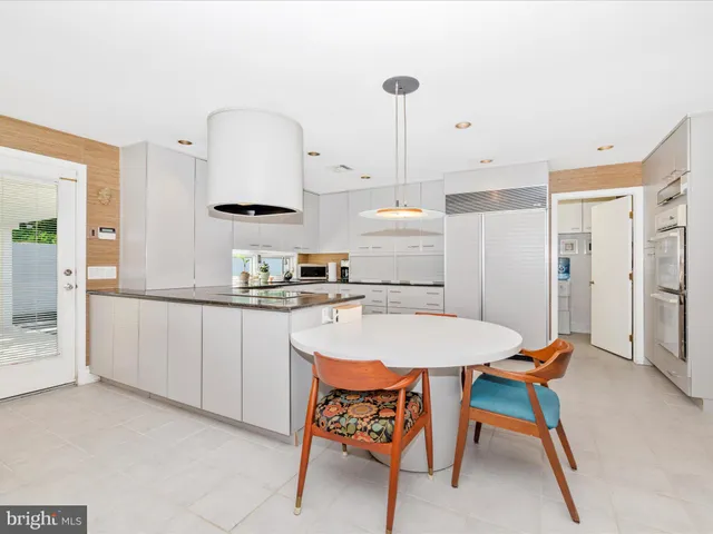 a kitchen with cabinets appliances a sink and a window